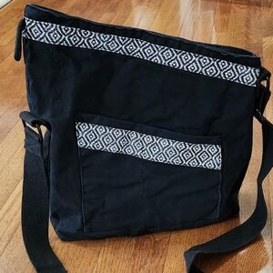 Black messenger bag/cross body bag with black and white design.
